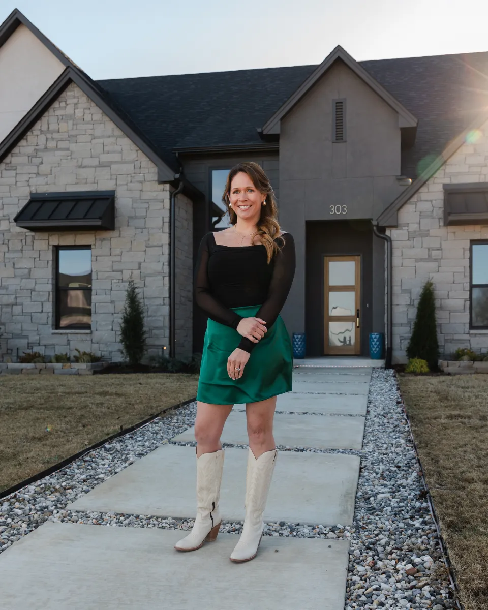 Allie Hodges standing outside a newly built home in Broken Arrow, Oklahoma.