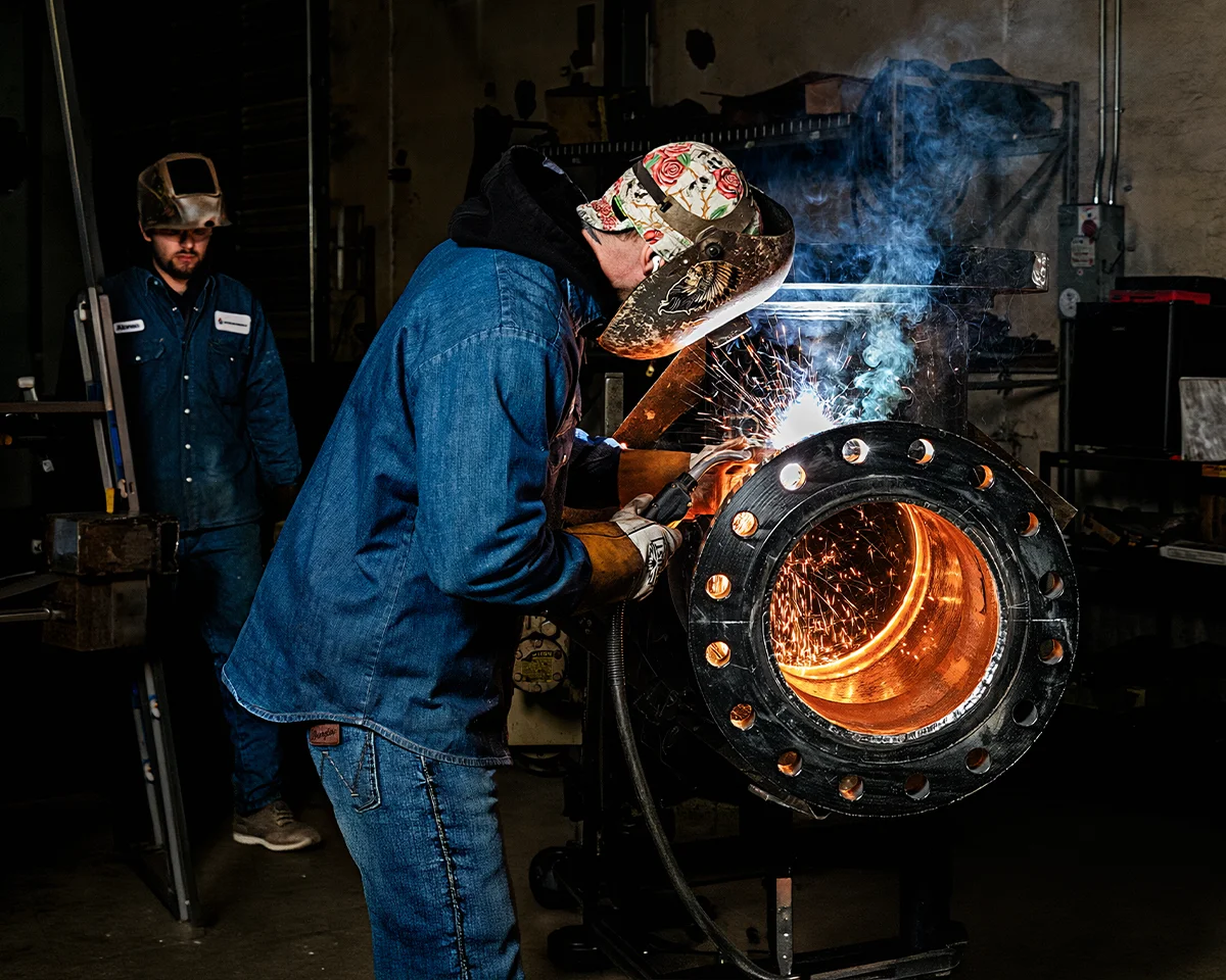 Steven Gulley completing welding details on a large American Wheatley flow divider before finishing.