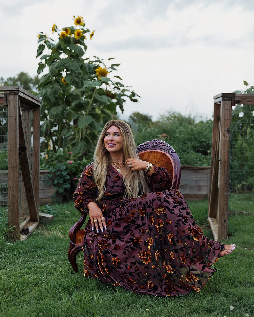 Brooke Burger seated in front of her garden during a Tulsa Real Producers cover shoot.