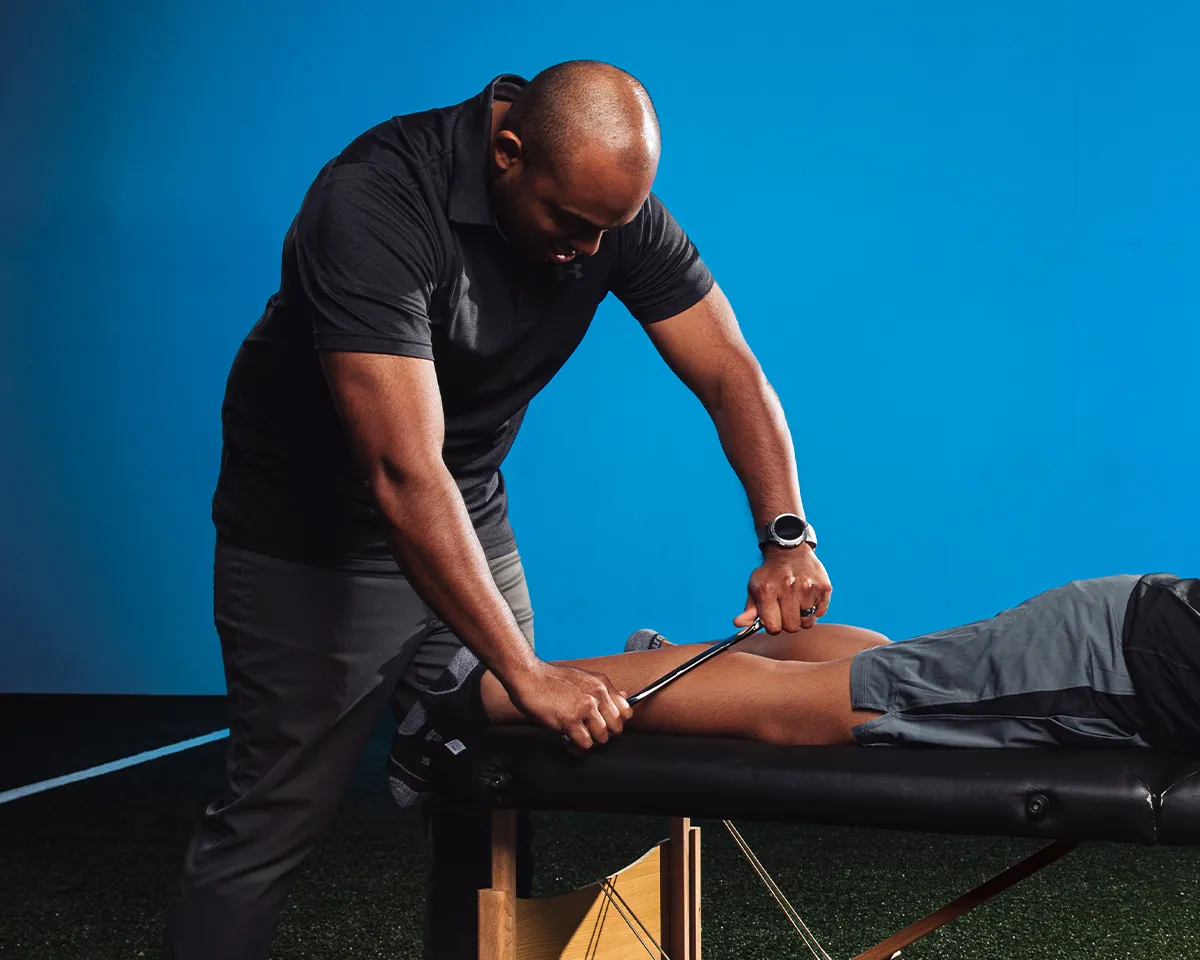 Physical therapist Jonathan Barber working with a youth athlete during a sports performance session in Bixby, Oklahoma.