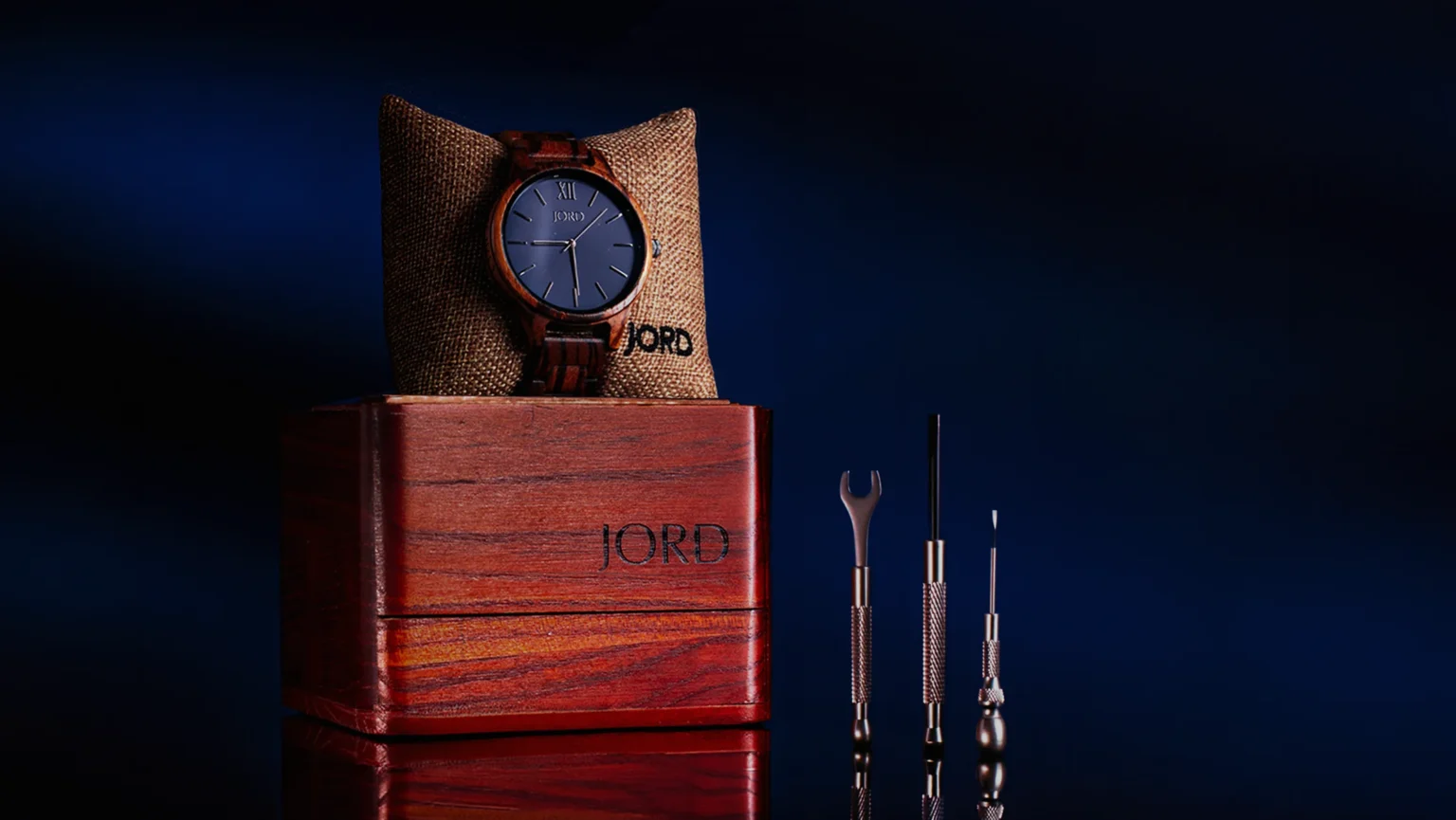 JORD watch crafted with Zebra wood photographed with its wooden case and watch tools.