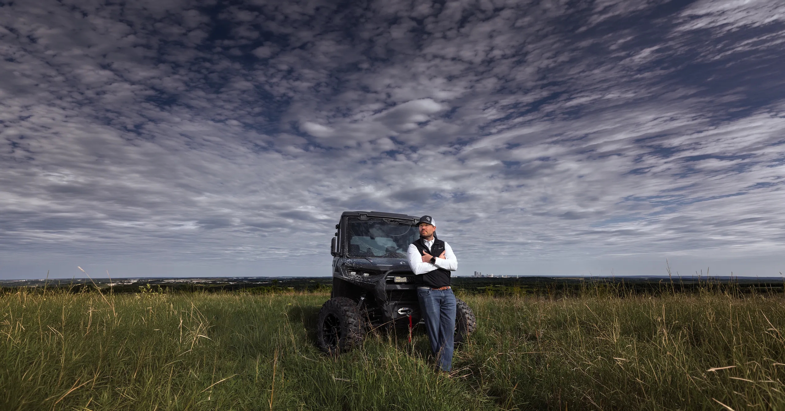 Environmental Portrait G7 Ranches Realtor JP Hewitt at POSTOAK overlooking the Tulsa skyline beside his UTV.