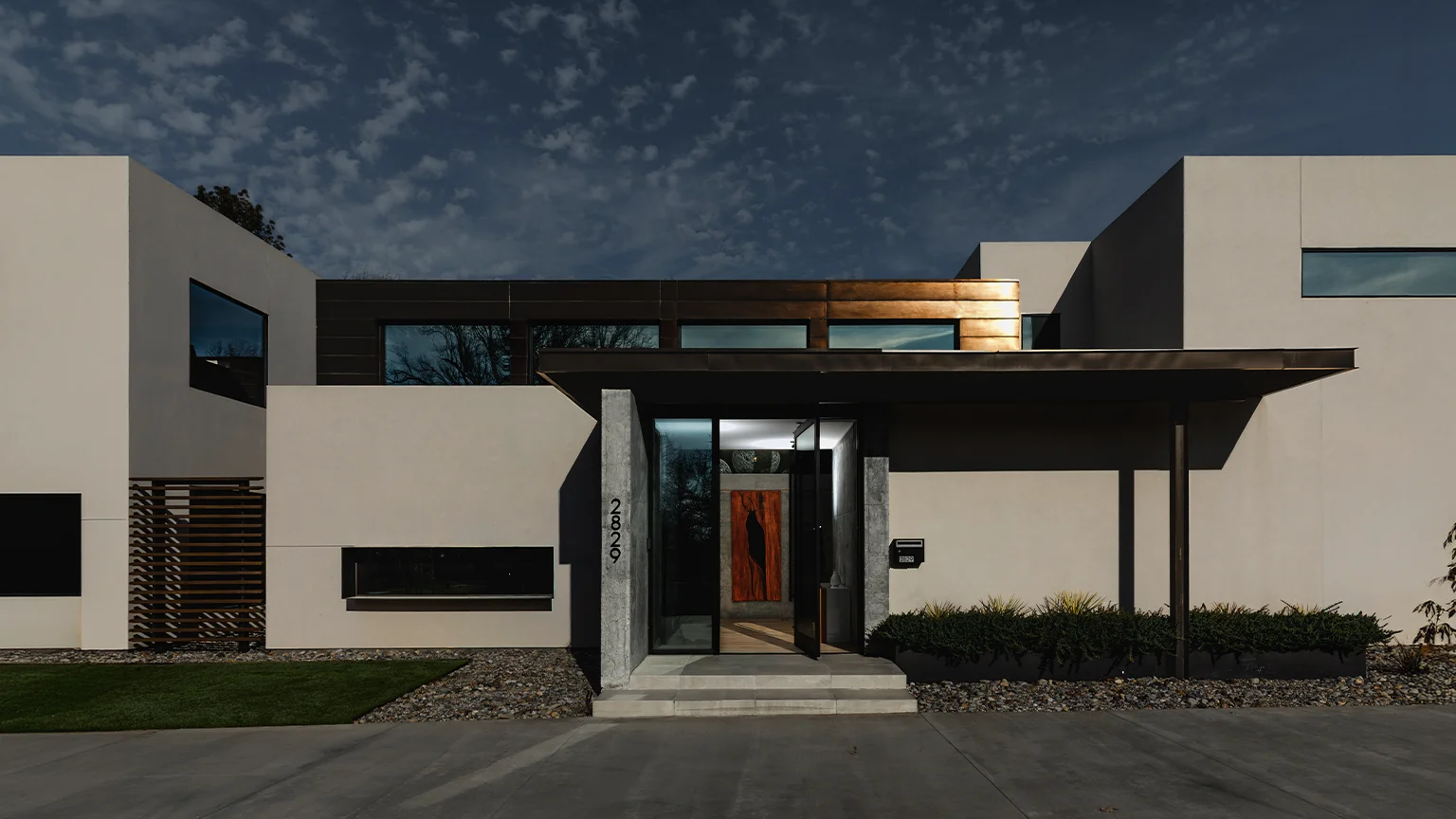 Modern home exterior in Brookside, Tulsa, featuring clean architectural lines and a covered entry.