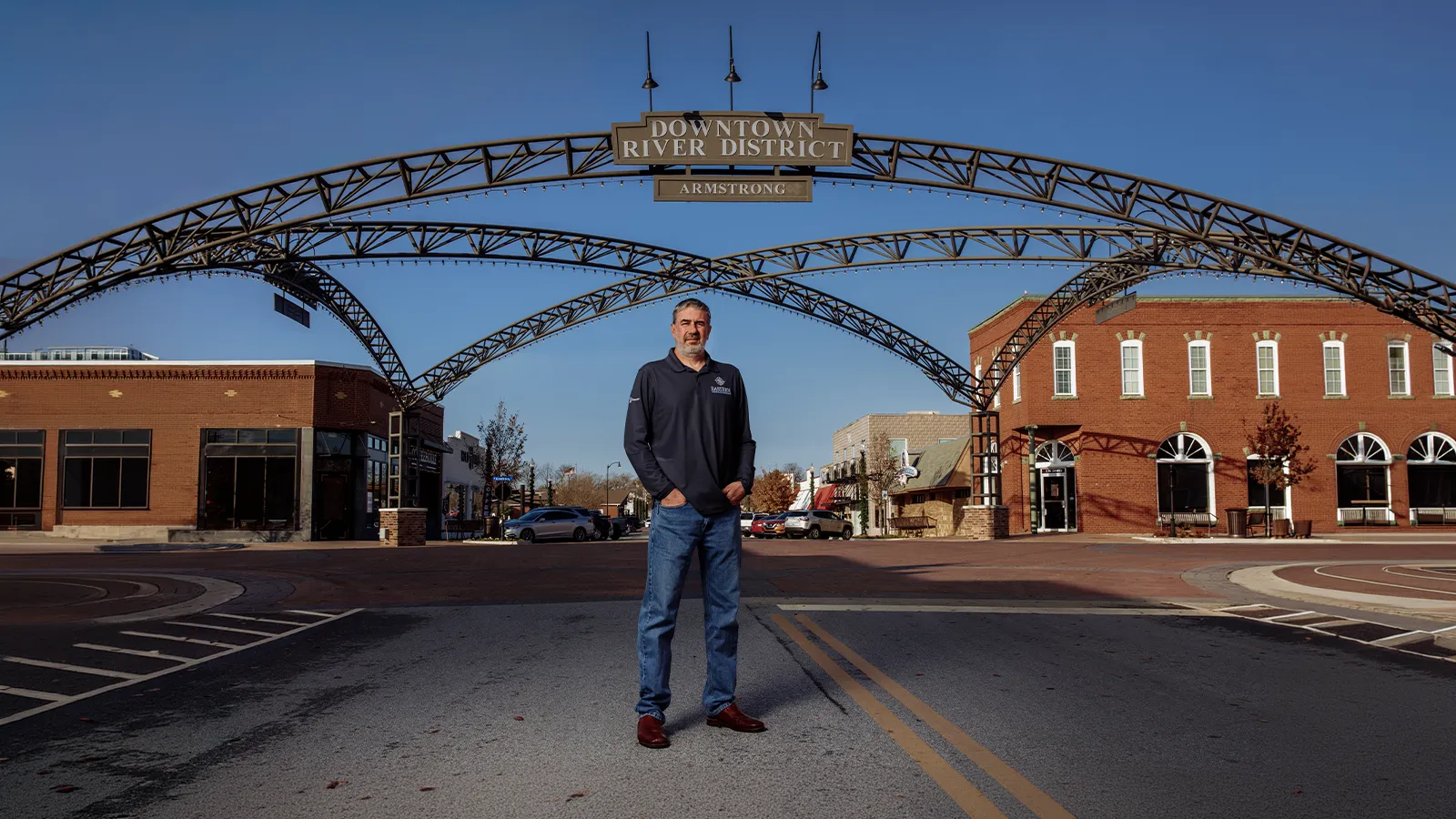 Ryan King of Eastern Title standing beneath the Downtown River District entrance in Bixby, Oklahoma.