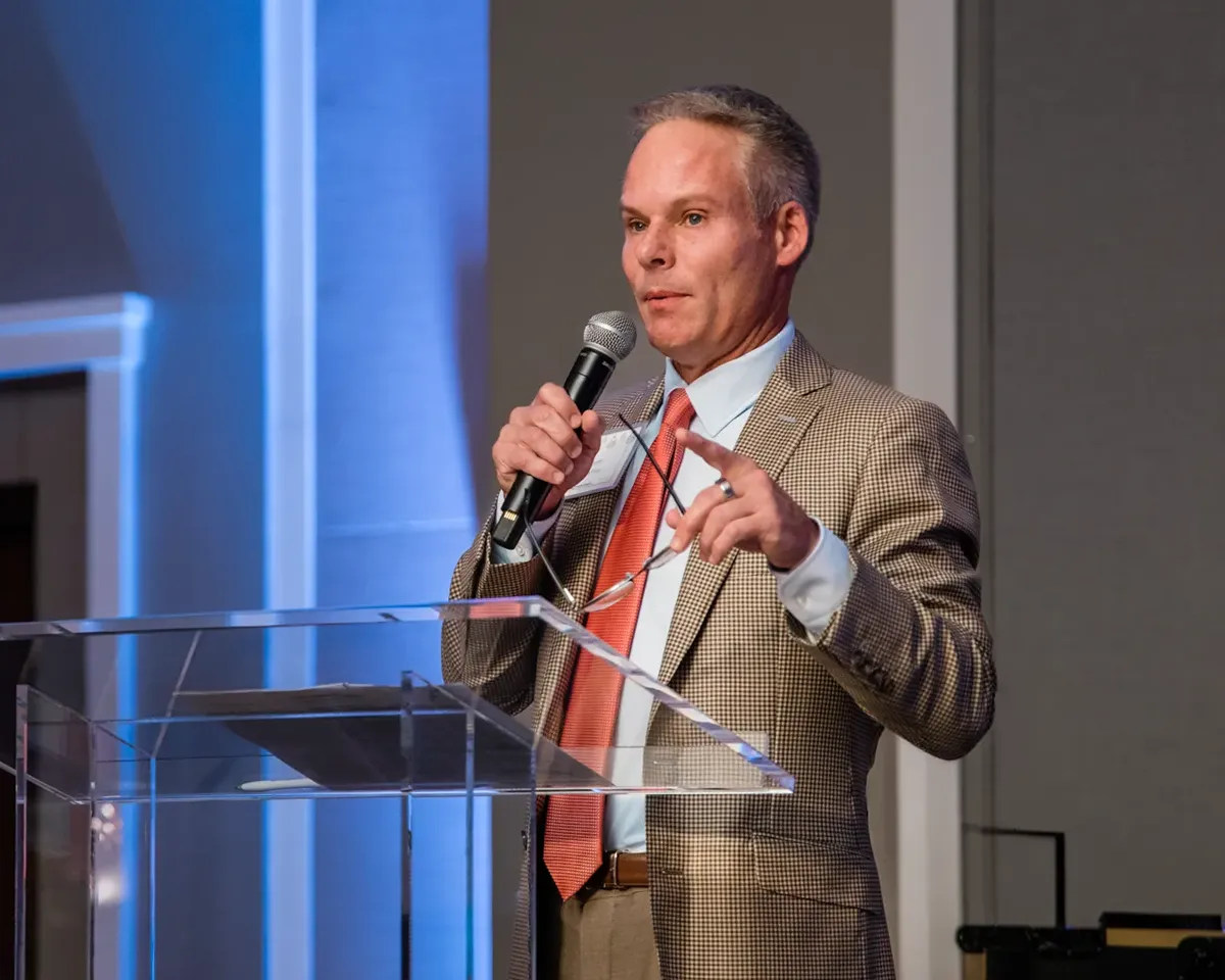 Mabrey Bank CEO Scott Mabrey speaking to employees during the company holiday dinner at River Spirit Casino in Oklahoma.